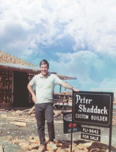 peter shaddock standing next to custom builder brand sign for sale